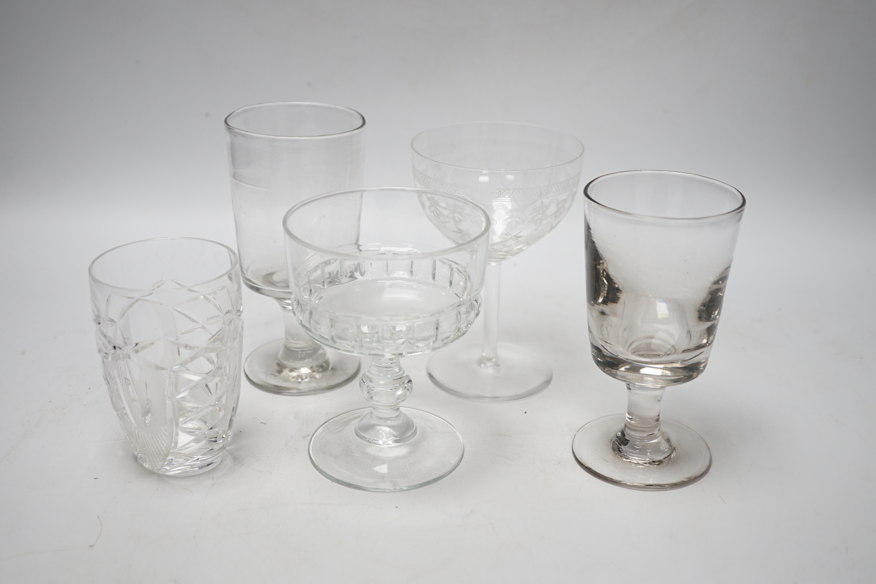 A collection of glassware including nine coupe glasses etched with butterflies and leaves